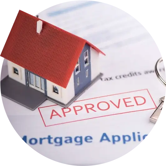 Small model house on mortgage application with "Approved" stamp in red